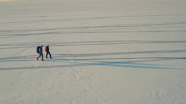 Aerial View Two Travelers Walking Snow Field — Stok Foto