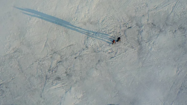 Upper View Two Travelers Walking Icy Field — kuvapankkivalokuva