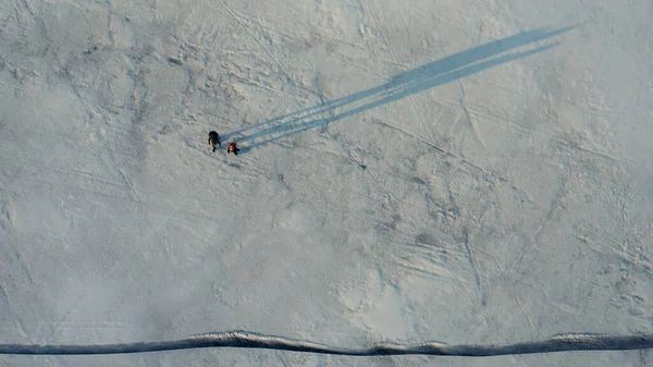 Upper View Two Tourists Walking Snow Field — kuvapankkivalokuva