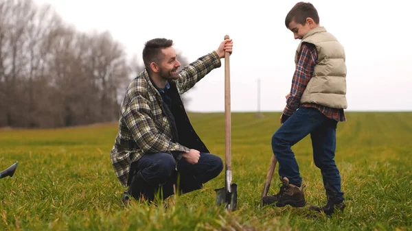 Dad His Little Son Planting Tree Field Stockfoto