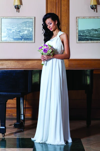 Indoor portrait of sexy bride with black piano — Stock Photo, Image