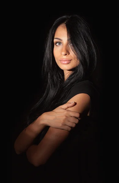 Glamorous woman with black hair on dark background — Stock Photo, Image