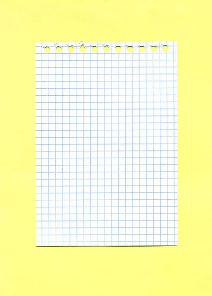 Checked Paper Sheet Torn Out Spiral Notebook Isolated Yellow Background — Stock Photo, Image