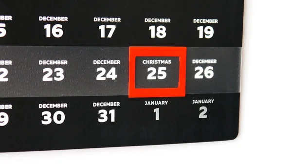 Duvar takviminin kara Aralık sayfasıyla Noel gününde kırmızı imleç yakın plan