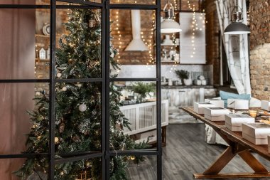 rustic kitchen interior on a brick wall background with lamps and a fir tree decorated for Christmas 