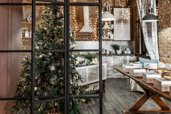 rustic kitchen interior on a brick wall background with lamps and a fir tree decorated for Christmas 