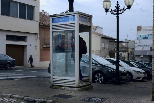 Homem sério a ligar para uma cabine telefónica na rua. — Fotografia de Stock