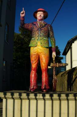 Galway, Ireland - August 2022. Colorful statue of a man rising hand finger at Galway community pride, concept lgtbiq . High quality photo