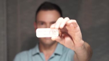 Person displays a combined covid-19 and flu A+B antigen test. First dual test arrived to the market