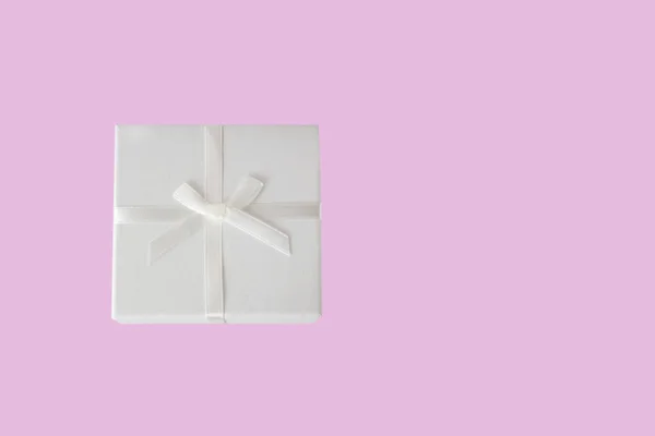 ピンクに隔離された白い弓とギフトの白い箱 休日のコンセプト — ストック写真