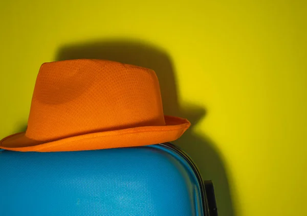Orange Sun Hat Close Blue Suitcase Yellow Background Summer Travel — стоковое фото