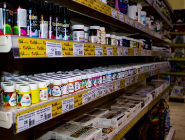 Zhytomyr, Ukraine - January 16, 2022: Different Color Paint Dispenser in the Art Supermarket. Painted and Stacked Paint Cans on the Graffiti Shelf. Paint Spray Shop. Art Store.