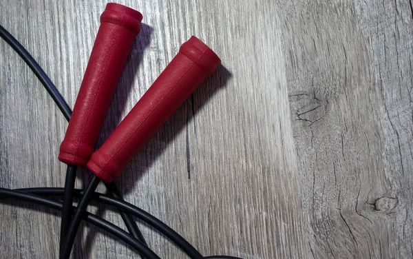 Açık Ahşap Arkaplanda Kırmızı Kollu İp. Spor Aksesuarları Kapanışı ve Metin İçin Boşluğu Kopyala. Spor ve sağlık kavramı.