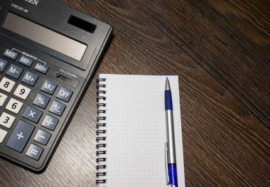Hesap makinesi ve not defteri. Top View of Calculator, Notepad with Pen, Kişisel Gelir Planlama. Finansal konsept. Hesap makinesine Para Planı yazarak.