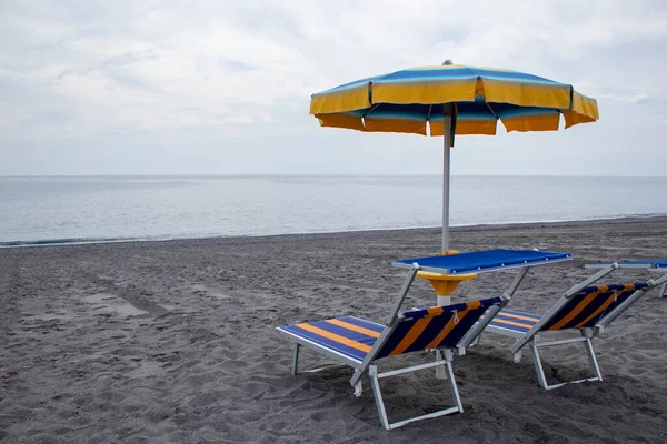 Umbrellas and Sunbeds on the Beach. Recreation and Tourism concept. Sunbeds on the beach of Italy. Summer and Travel concept. Beach with Sun loungers and Umbrella.