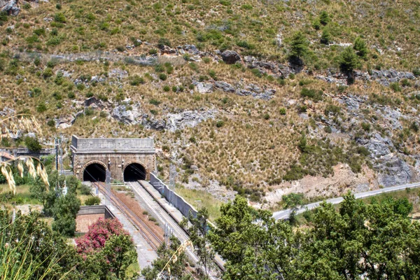 Entrance to the railway tunnel. View from above. Tunnel in the mountains in Italy.