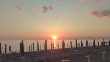 Beautiful Tropical Sunset Landscape, Deck Chairs, Umbrellas. White Sand, sea View with Horizon, Colorful Twilight Sky, Tranquility and Relaxation. Inspirational Beachfront Resort. Summer Vacation Concept.