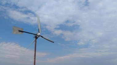 Windmill Power Generator Fan, Under Blue Sky, Shown as Power Industry Concept. Energy Saving Concept. Natural Resources.