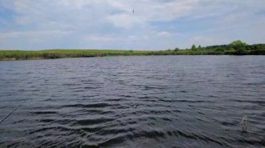 Fishing in the Open air Near the River in a Picturesque Place. The Fisherman Caught a Crucian Fish. Good Fishing in the Morning.