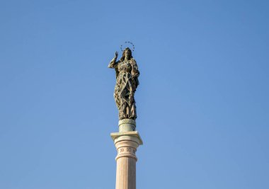 Statue of the Virgin Mary against the Blue Sky in Calabria, Italy. Symbol of the City of Salerno in the South of Italy, on the coast of the Tyrrhenian Sea.