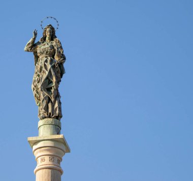 Statue of the Virgin Mary against the Blue Sky in Calabria, Italy. Symbol of the City of Salerno in the South of Italy, on the coast of the Tyrrhenian Sea.