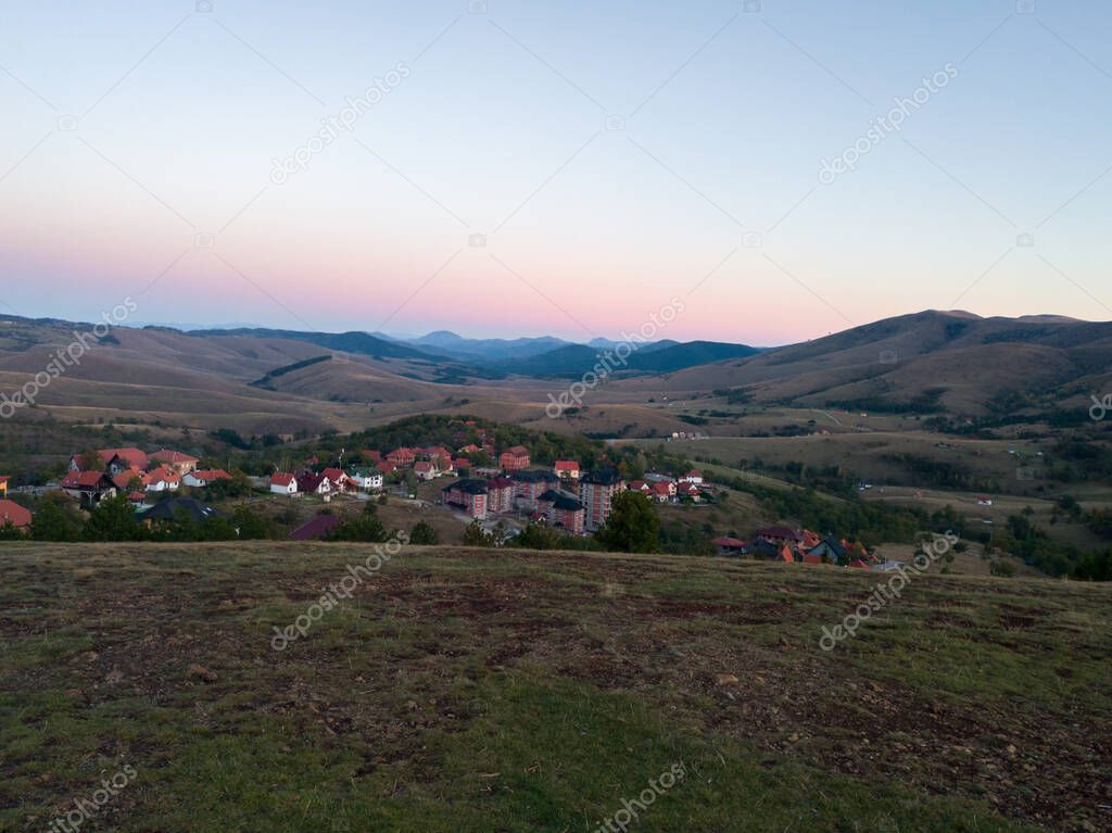 View from the lookout on Sumatno hill on the mountain landscapes of Zlatibor and the tourist building in the autumn at dusk