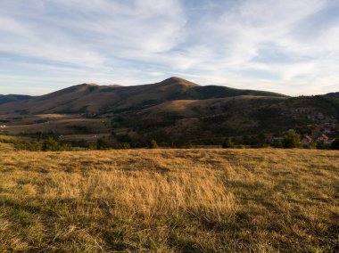 Sumatno tepesinden Zlatibor 'un dağ manzarasına ve sonbaharda gün batımında turist binasına bakın.