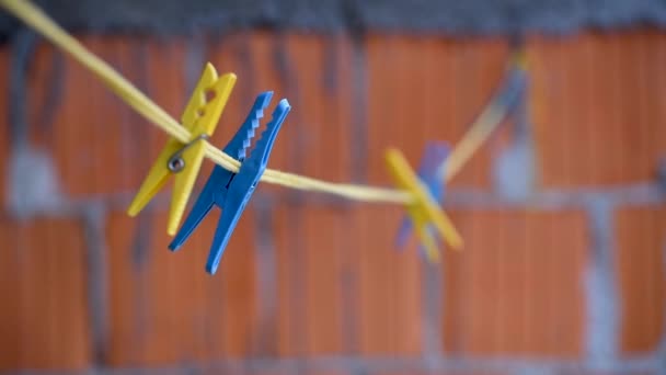 Laundry Pegs Clothes Pins Attached Launtry Cord White Swinging Wind — Stock Video