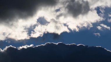 Arka plandaki bulutlar arasındaki uçurum, gökyüzü boyunca hareket ediyor.