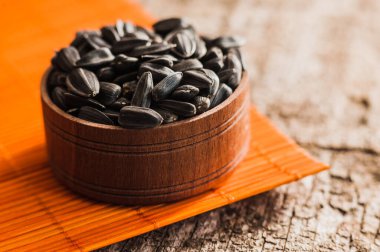 Taze ayçiçeği tohumu ve yağ. Tahta kasede kabuklu ayçekirdeği..