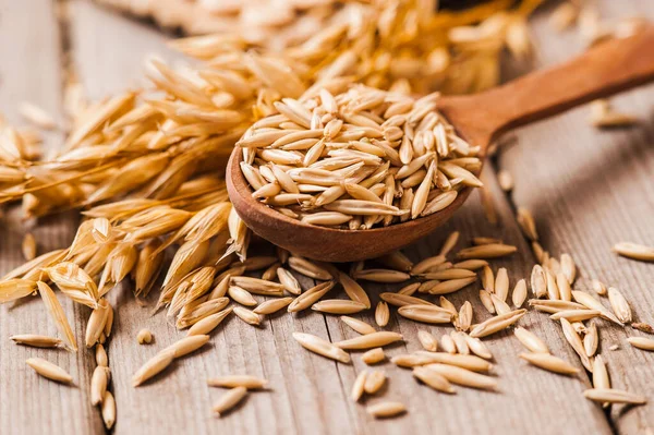 Yuvarlanmış yulaf ve yulaf taneleri ahşap bir masada, boşluğu kopyala.