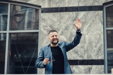 İş adamı toplantı için bekliyor. Adam el sallıyor..