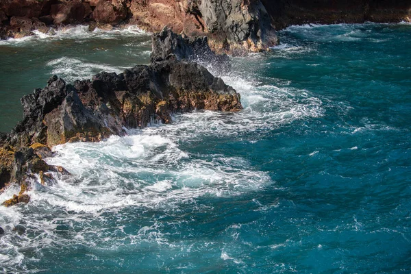 A tenger összeütközik a kövekkel és a homokkal. Tengeri hullámok szempilla vonal ütközés szikla. — Stock Fotó