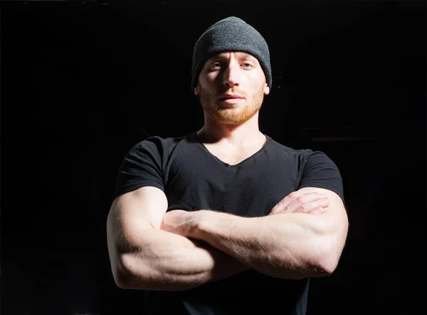 Portrait closeup of handsome man with crossed arms on black studio. — Stock Photo, Image