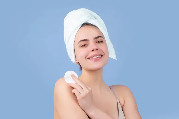 Cosmetic cream on woman face with clean soft skin. Body care. Woman with towel applying cream on skin. Body care and spa salon concept. Spa girl. Beautiful young woman with perfect skin. — Stock Photo, Image