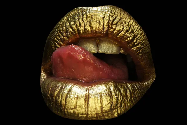 Sexy tongue. Sensual lick. Sexy girl golden lips, gold mouth. Glowing gold skin make-up. Glitter metallic shine golden lipgloss makeup.