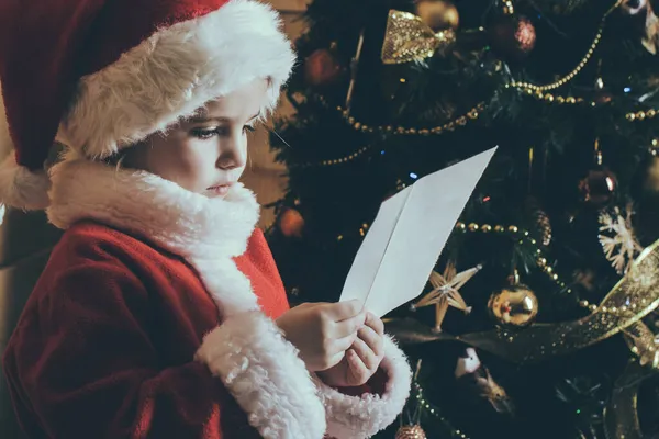 New year small girl with wish letter to Santa. Christmas happy child read wish letter. — Stock Photo, Image