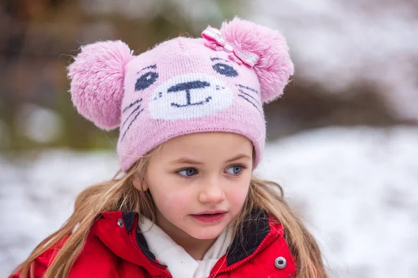 Close up portrait of cute girl playing in winter snowy park. Christmas holiday, winter weekend for kids. Cute kids face. — Stock Photo, Image