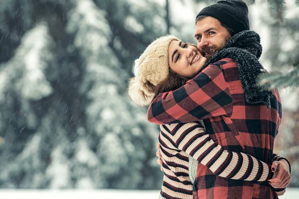 Casal feliz de inverno no amor abraçar na floresta fria nevada, férias de inverno amor e relações. — Fotografia de Stock