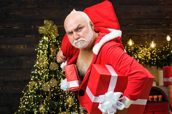 Christmas safety from burglars and home security. Holiday crime scene with bad Santa in the mask with bag. — Stock Photo, Image