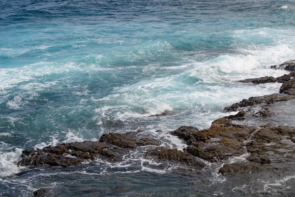Šplouchající vlny na skálu v moři. Vlna narazila na kámen v oceánu s trubkou pozadí. — Stock fotografie