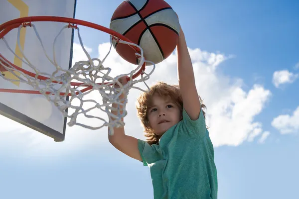 篮球少年运动员把球灌入水中.儿童篮球运动员灌篮. — 图库照片