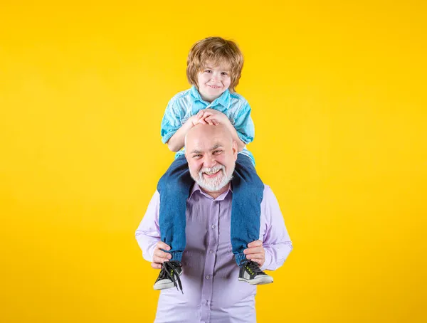 Grandfather and son piggy back ride with funny face isolated.