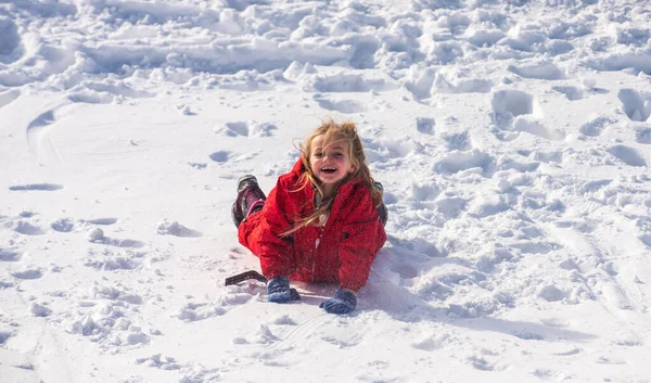 Komik küçük kız kış günü dışarı çıkıyor. Heyecanlı bir Noel tatili. Karda yatan tatlı kız.. — Stok fotoğraf