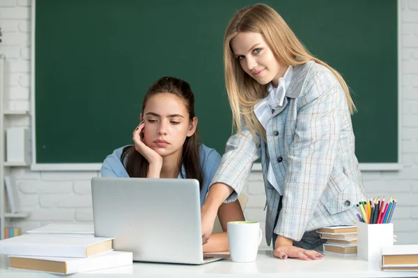 Okul ya da üniversitede kız öğrenciler sınıf arkadaşlarıdır. İki öğrenci ödev yapıyor ve birbirlerine yardım ediyorlar.. — Stok fotoğraf