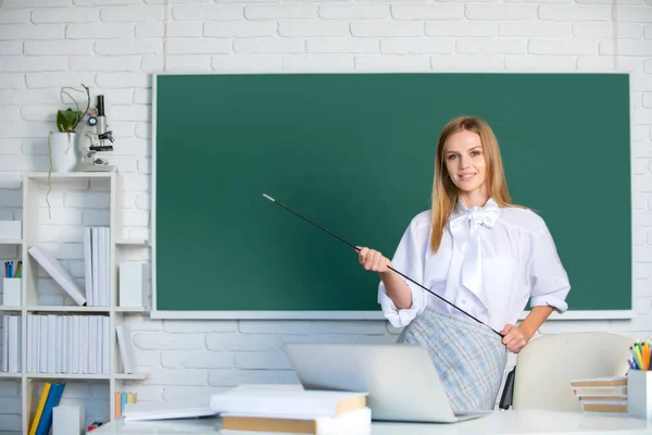 Successful female student at classroom of university. High school student learning english or mathematics in class. — Stock Photo, Image