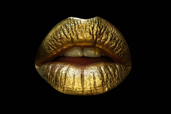 Closeup female plump lips with gold color makeup. Golden glitter cosmetic. Shine christmas style for sexy lips. Glamour golden lips. Isolated on black.