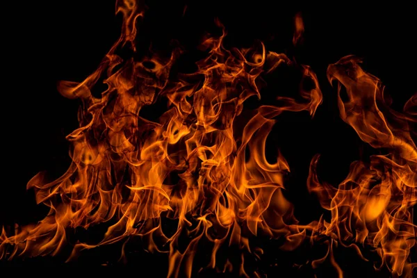Siyah arka planda ateş dokusu. Soyut yangın arka planı, büyük yanan ateş. — Stok fotoğraf