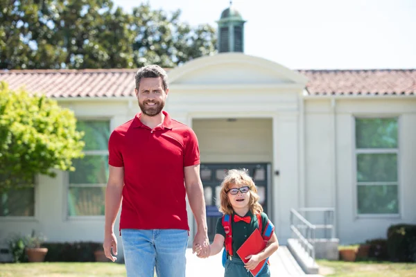 Father and son walking trough school park. — Stock Photo, Image