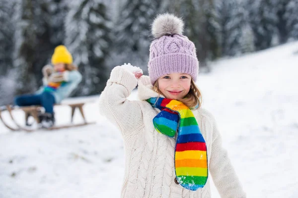 Fille enfant heureux jouant bataille de boule de neige sur une promenade d'hiver dans la nature. — Photo